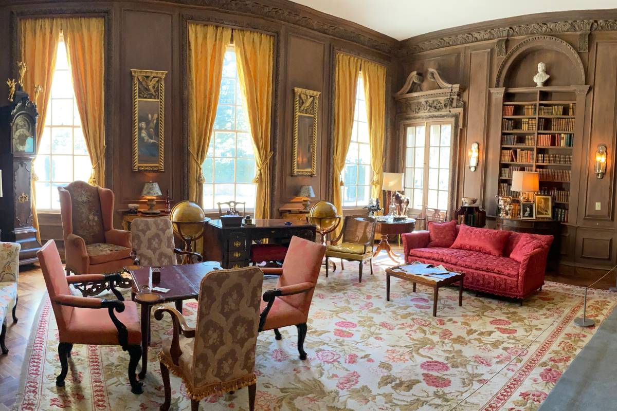 Inside of Swan House Atlanta featuring grand drawin room with sofas and draped curtains
