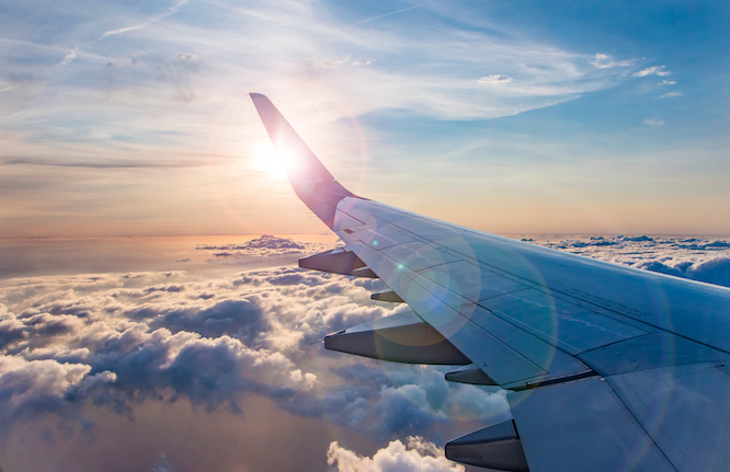 flying and traveling, view from airplane window on the wing on sunset time
