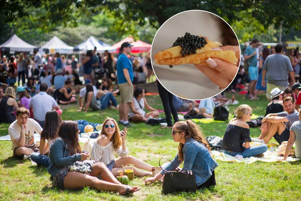 smorgasburg food festival with a hand holding caviar