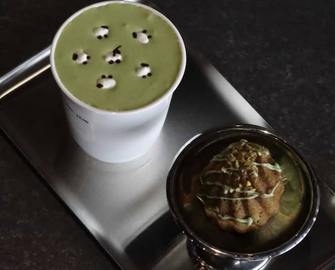 a green matcha latte with little sheep drawn in