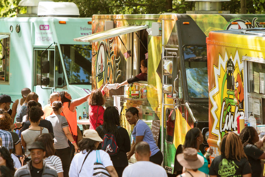 ATLANTA, GA - APRIL 16: A crowd of people buy meals from food trucks lined up in Grant Park at the Food-o-rama festival on April 16, 2016 in Atlanta, GA.