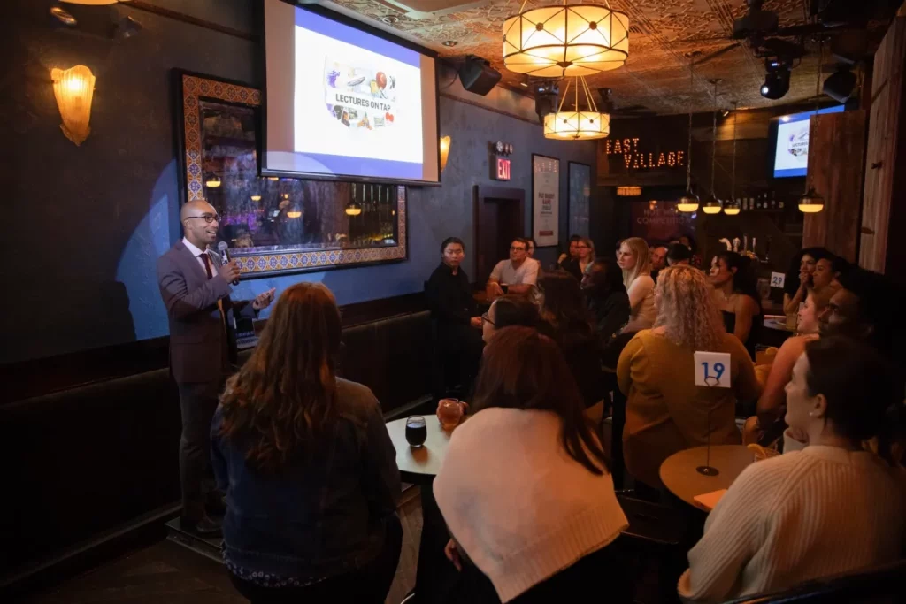a professor giving a lecture at a bar