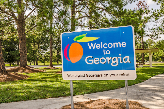 State sign for Georgia welcomes visitors in a shaded rest area