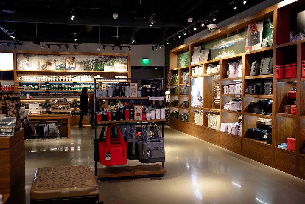 San Jose, CA US - November 23, 2025: The image shows the interior of YETI retail store at Santana Row in San Jose, California, offering outdoor gear, drinkware, apparel, bags, and various accessories.