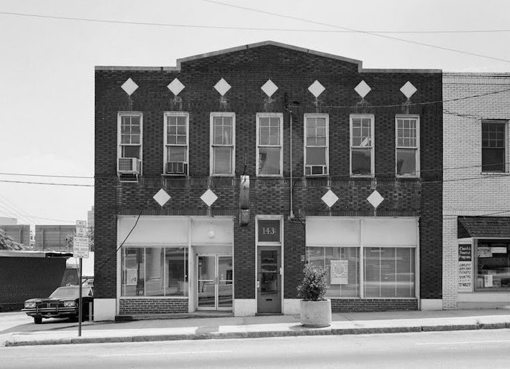 an old black and white photo of a brick building