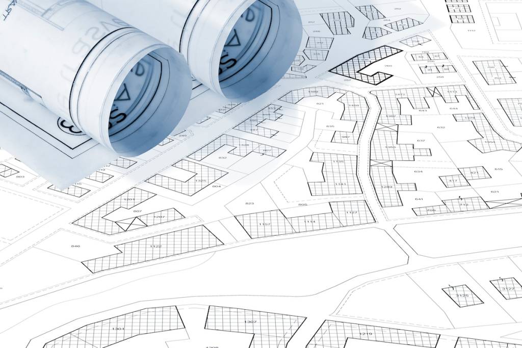 Mapa catastral imaginario con edificios, parcelas y solares vacíos: concepto de registros catastrales y del registro de la propiedad