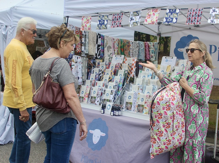 woman shopping at a tent at a festival