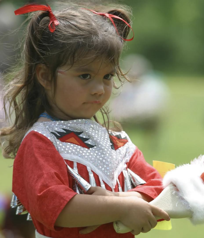 Native American child with bows in her hair