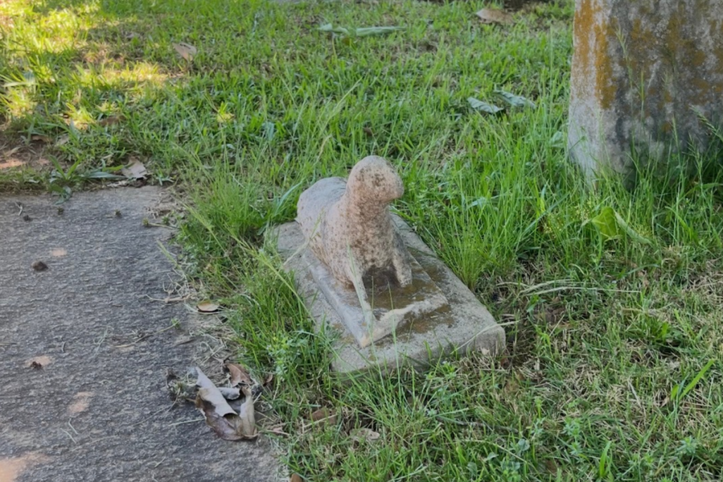 A grave w a lamb on it