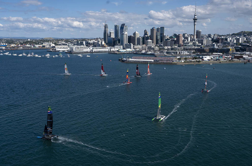 A long-distance shot of the SailGP catamarans sailing in the harbour.