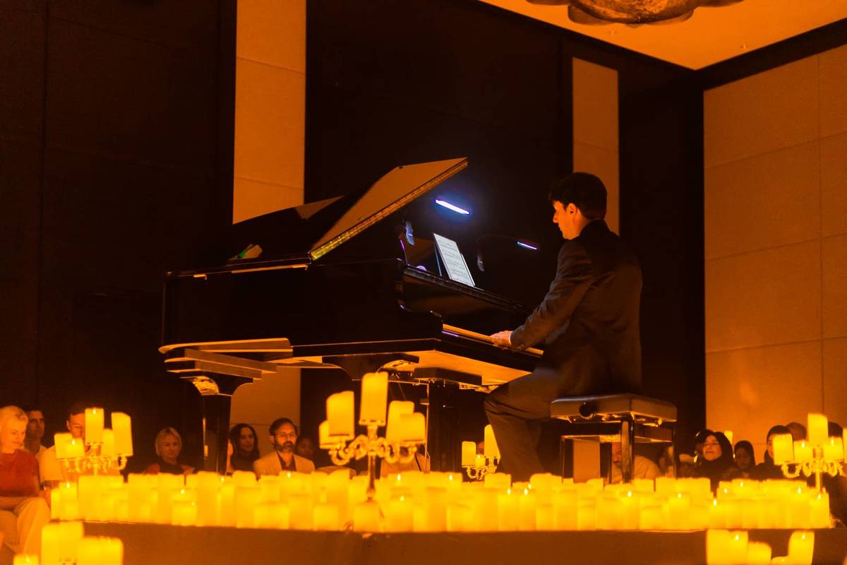 A pianist performing by candlelight in Austin