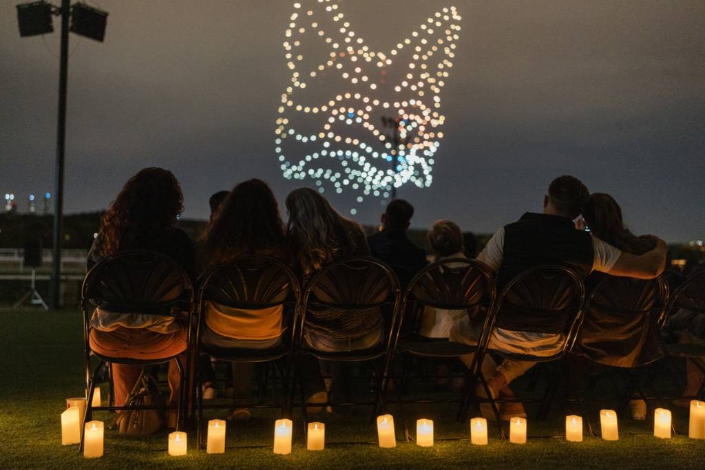 Illuminated drones fly over a string quartet