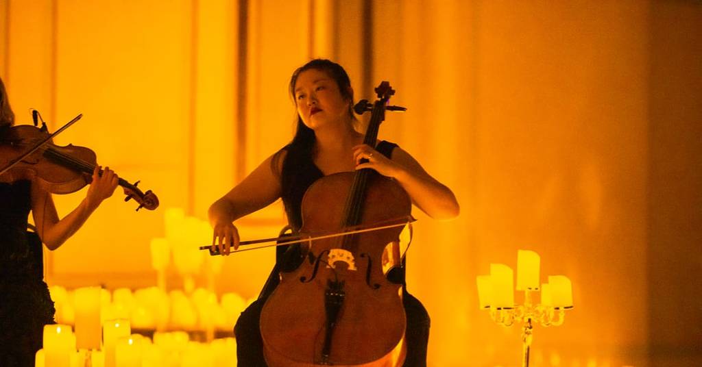 A musician playing the cello at a Candlelight concert