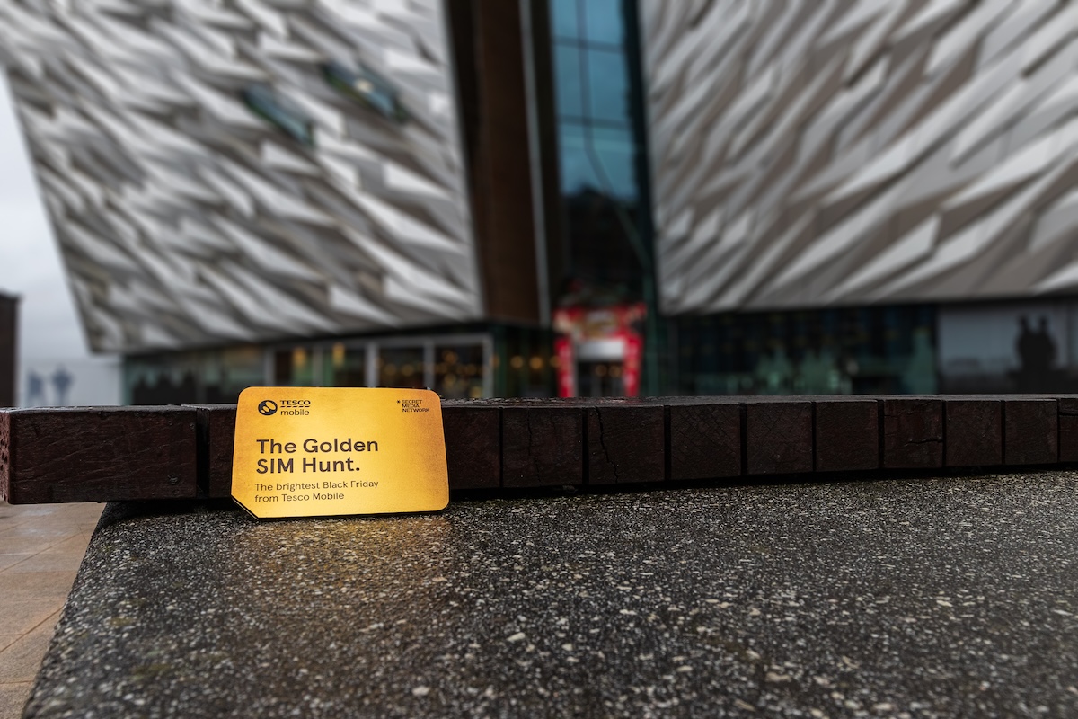 a tesco mobile golden sim card hidden by a belfast monument