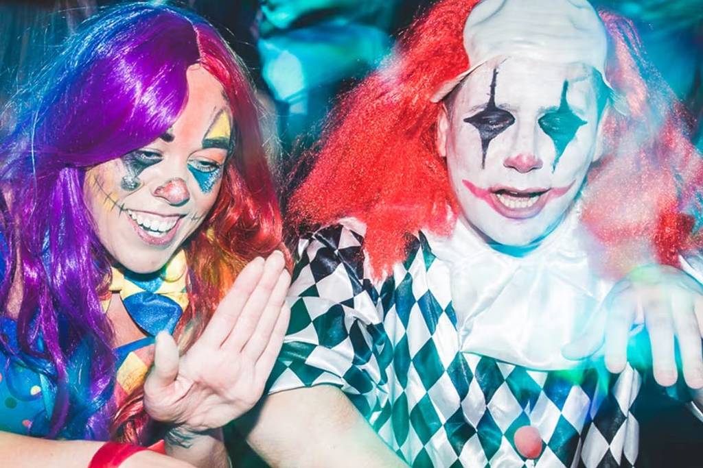 Two people dressed up as clowns for Halloween
