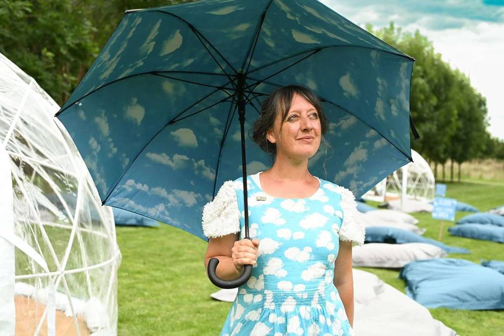 A woman wearing a clouf dress with an cloud umbrella in Birmingham Botanical Gardens