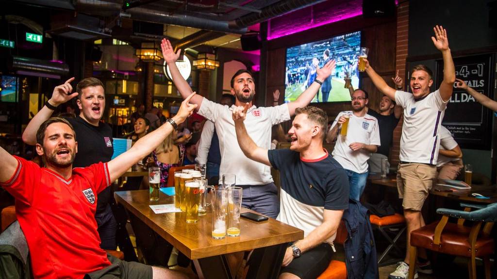 A group of men cheering on England