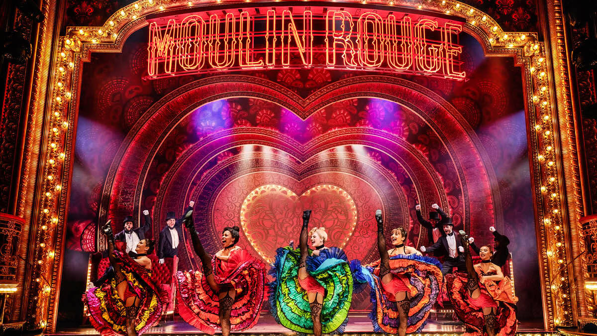 Moulin Rouge! The Musical - dancers performing under the Moulin Rouge sign