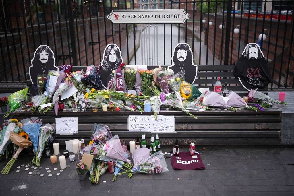 BIRMINGHAM, ENGLAND - JULY 23: Flowers, candles, drinks and messages in memory of Ozzy Osbourne are left on the Black Sabbath Bridge bench on Broad Street on July 23, 2025 in Birmingham, England. Ozzy Osbourne, the legendary rock icon and Black Sabbath frontman, died on Tuesday, aged 76, after performing a farewell show in his hometown of Birmingham earlier this month. Over the course of his storied career as a singer-songwriter and media personality, he brought home five Grammy Awards and was twice inducted into the Rock and Roll Hall of Fame - once as a member of Black Sabbath, and again as a solo artist. (Photo by Christopher Furlong/Getty Images)