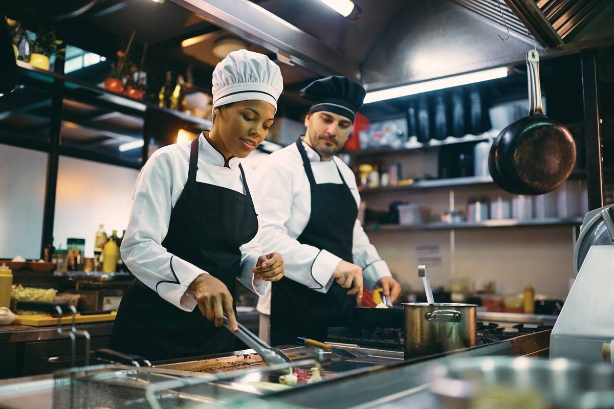 two chefs in a kitchen