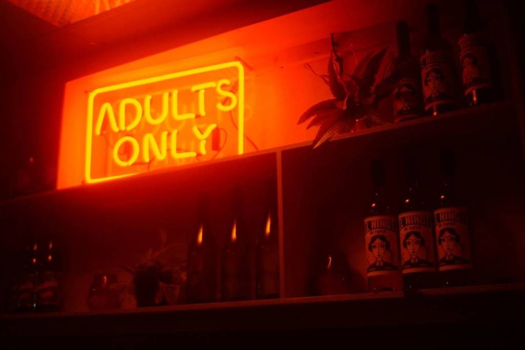 A neon sign at cheese and wine bar, Cheddar reading 