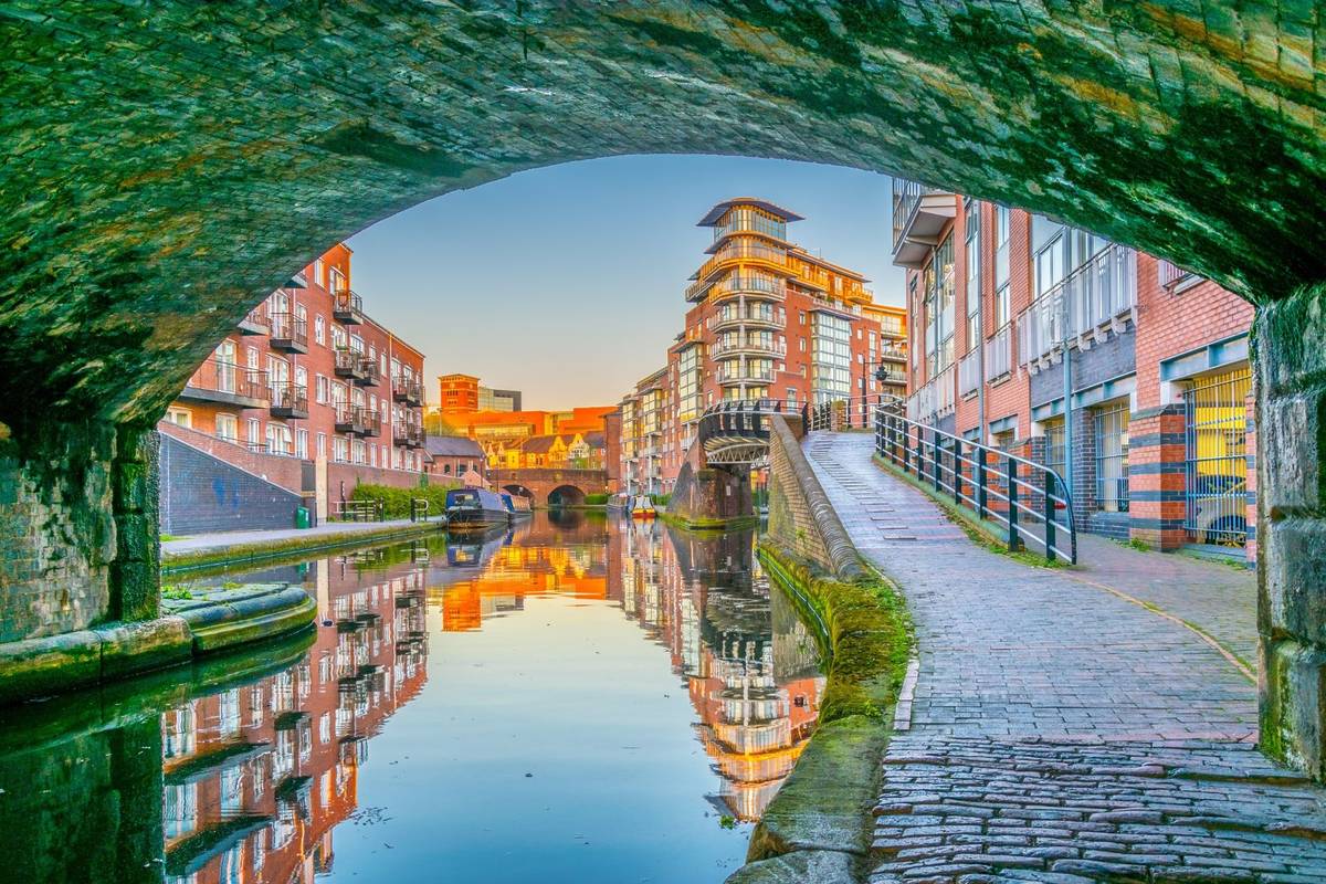 Sunset view of brick buildings alongside a water channel in the central Birmingham, England