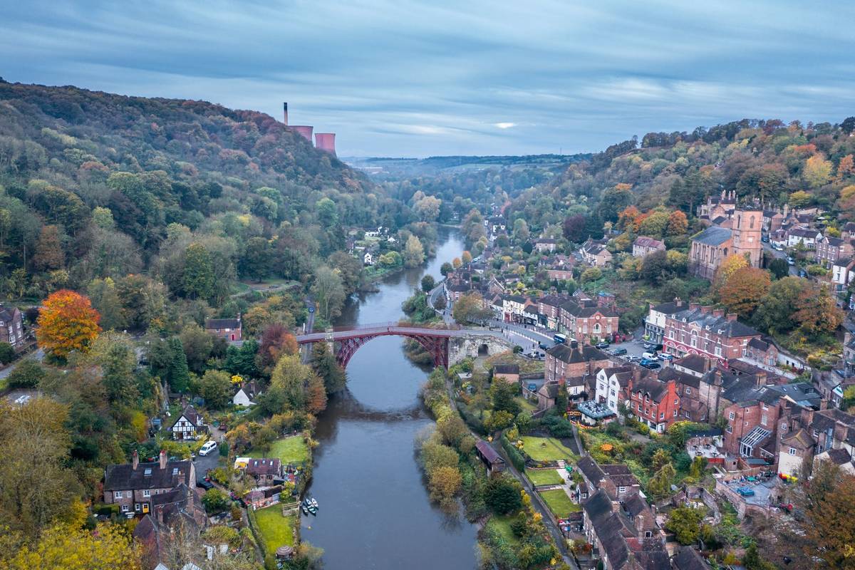 High altitude drone shoot over historic Victorian town at autumn. Ironbridge in Shropshire, UK
