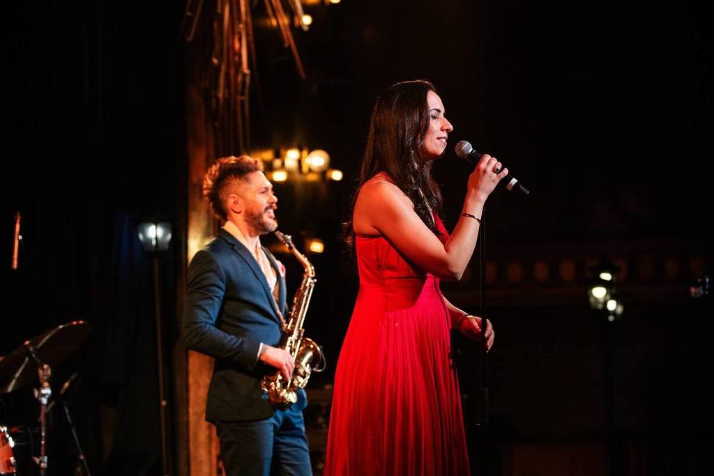 A singer and saxophonist performing on stage at The Jazz Room live music concert