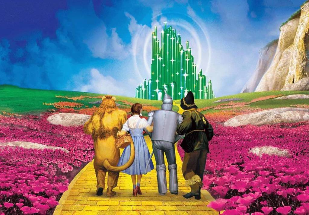 image of the characters from wizard of oz with the land of oz in the distance