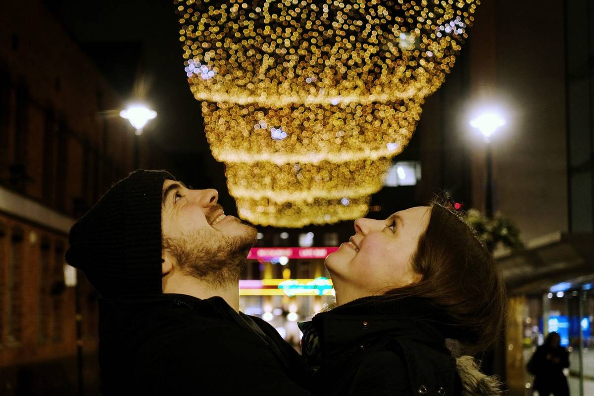 Two people looking up at a light installation