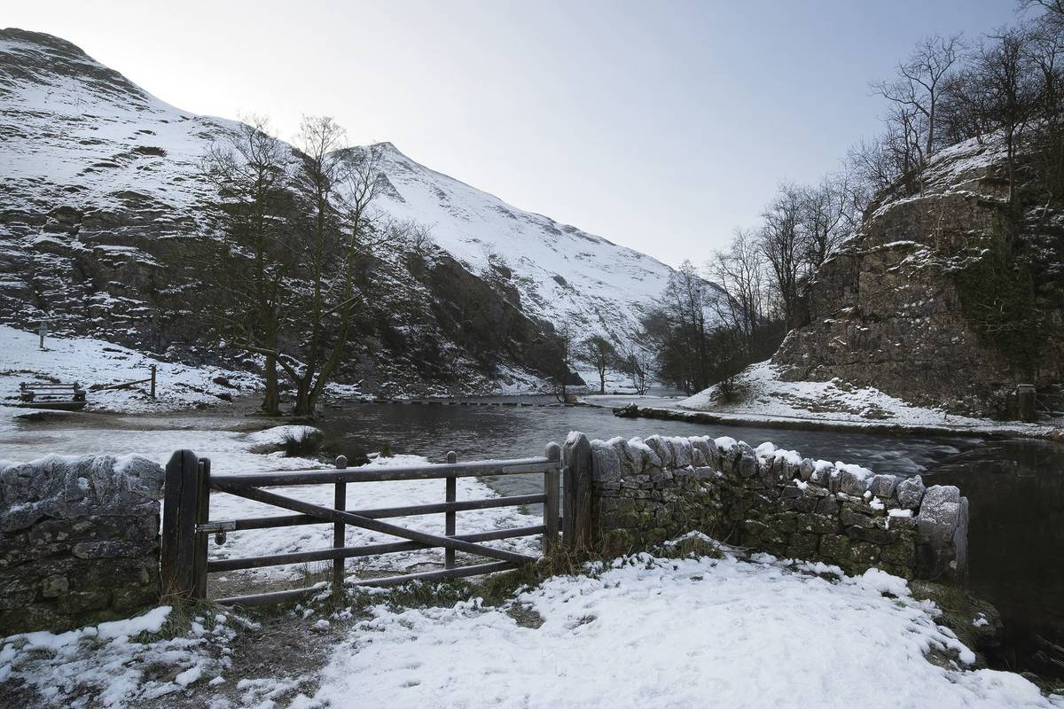 River flowing through snow covered Winter landscape in valley