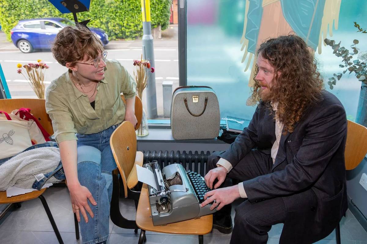 A man writing on a typewriter