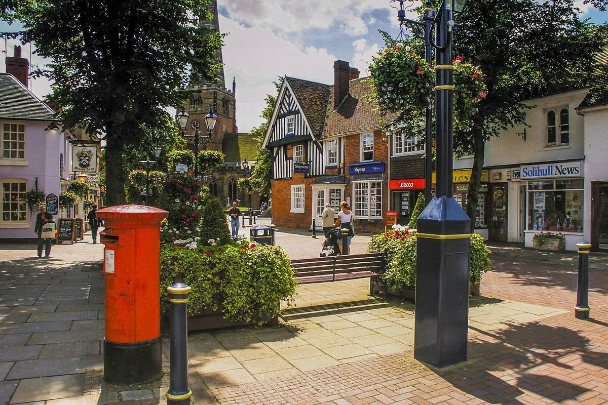 SOLIHULL WEST MIDLANDS UK ?? SEPTEMBER 26 2016: Town centre of Solihull. Sunny afternoon in late September and there are people walking around the streets and pedestrianised squares of the town.