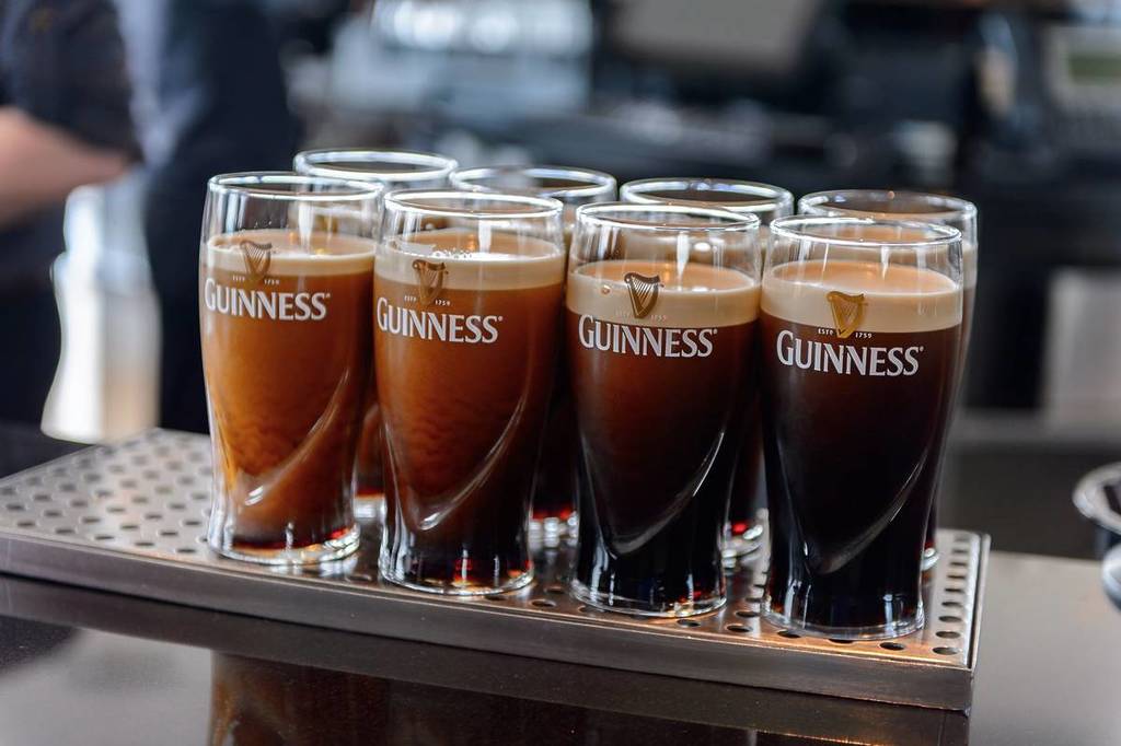 DUBLIN, IRELAND - JULY 12, 2016: Pints of Guinness in the museum in Dublin. Guinness is an Irish dry stout produced by Diageo originated in the brewery of Arthur Guinness