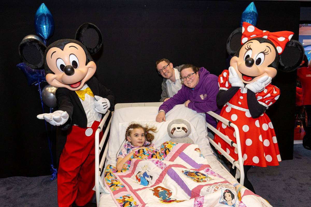 A patient with Mickey and Minnie Mouse at Birmingham Children’s Hospital