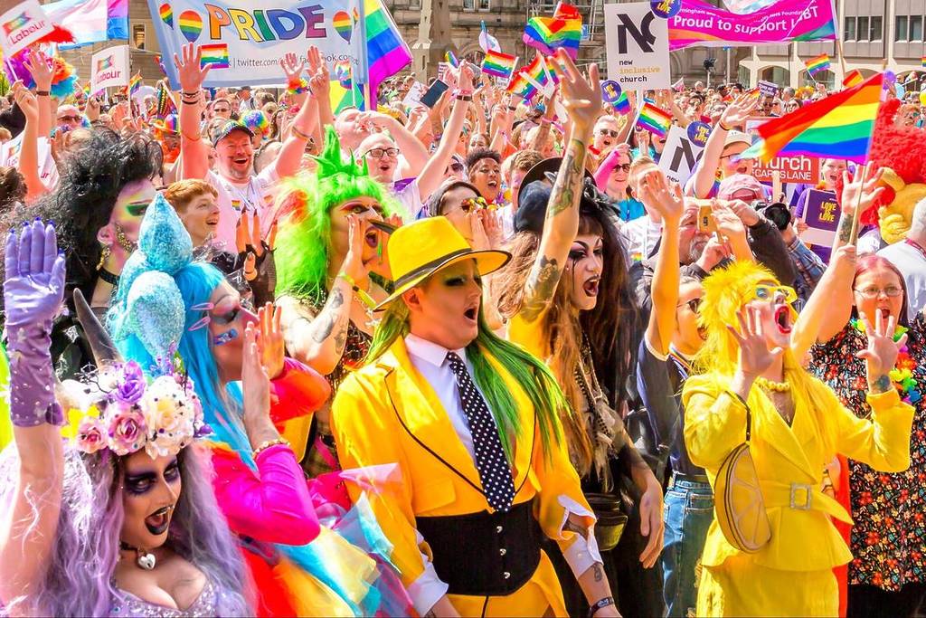 Birmingham, UK - May 5, 2019 - Cheering crowds gather in front of the stage in Victoria Square. They laugh and shout as the atmosphere builds prior to the Pride parade.