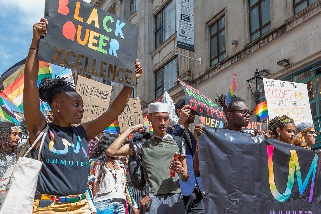 People of Colour carry flags and banners in support of the LGBTQI community in the Pride procession through the city centre.
