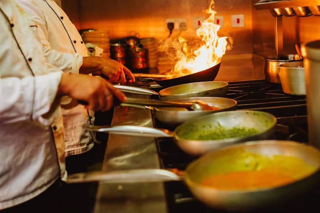 Chefs cooking curries in the Balti Triangle