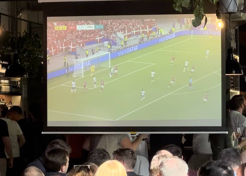 A buge screen showing an England football game at the World Cup