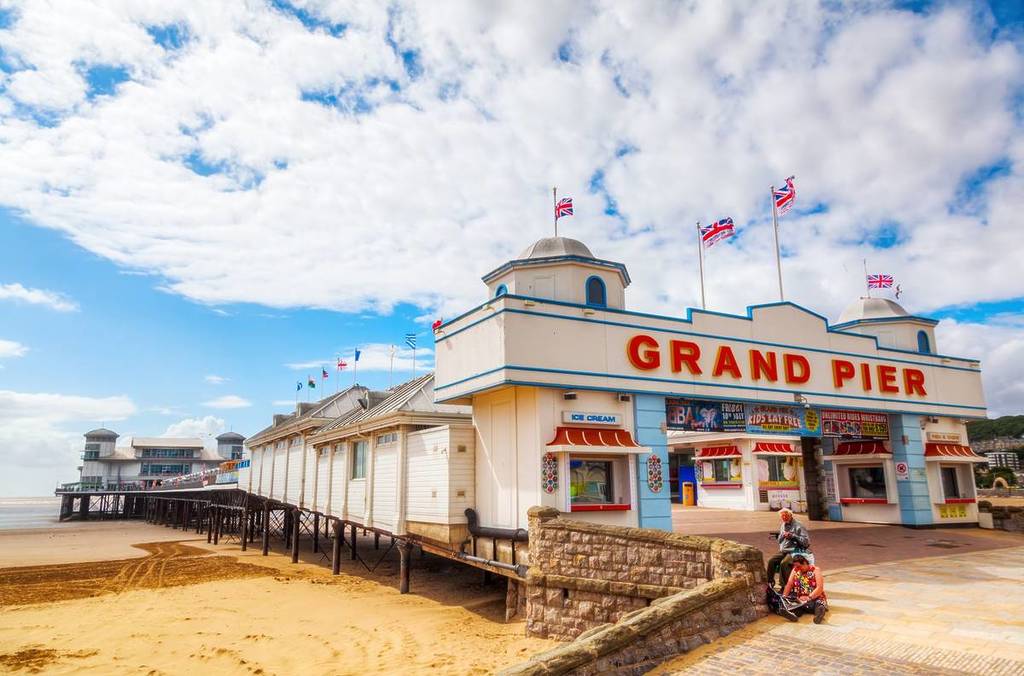 WESTON-SUPER-MARE - JULY 07, 2015: Grand Pier with unidentified people. The pier is a pleasure pier on the Bristol Channel, it has been damaged by fire 1930 and 2008. After 2008 fire new opened 2010