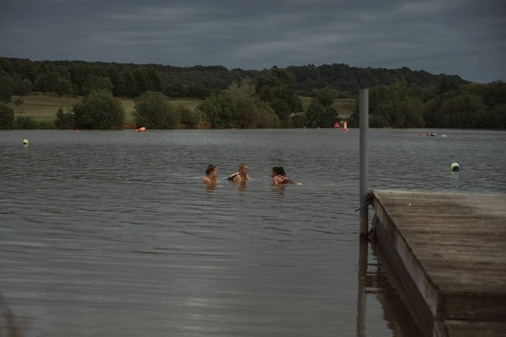 Three people swimming in the lake