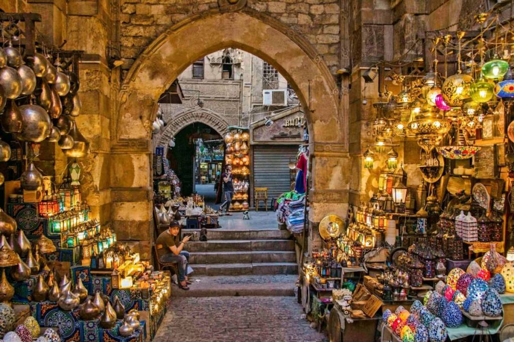 Khan el Khalili, Cairo, Egypt.
a narrow alley way with a lot of items on display