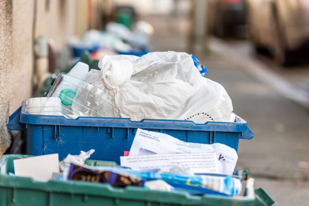 Day view plastice waste refuse bins boxes on British road