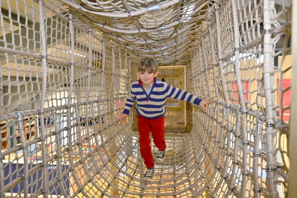 A child in a rope bridge at Hockerhill Adventure Playbarn