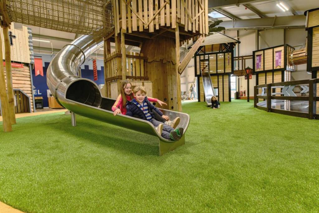 Children on a slide from the mock Oak Tree