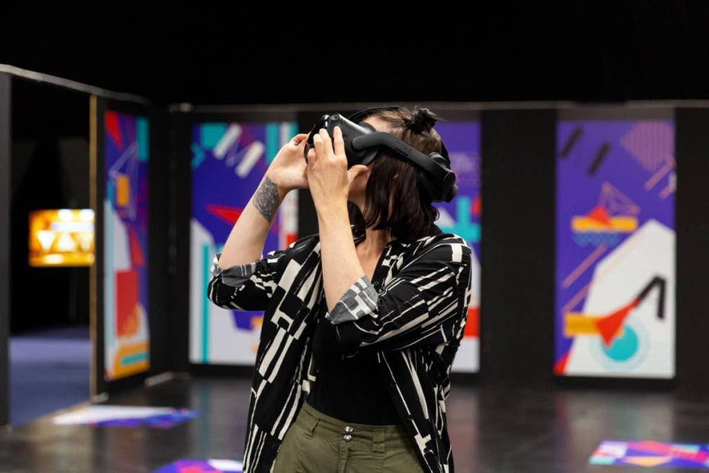 A woman wearinga VR headset in the metaverse inTutankhamun: The Immersive Exhibition