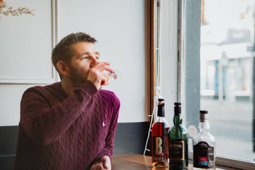A man drinking whisky