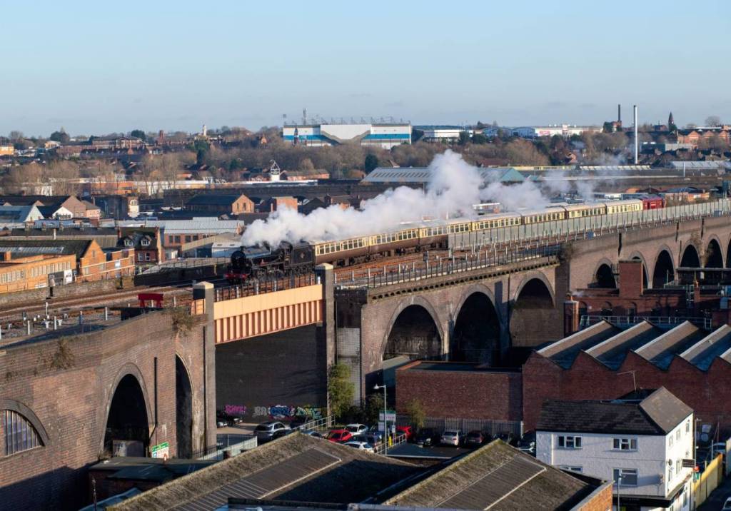 Birmingham,UK November 2019. Polar Express Christmas charter train with Black 5 preserved steam locomotive crossing Bordesley Viaduct, Birmingham
