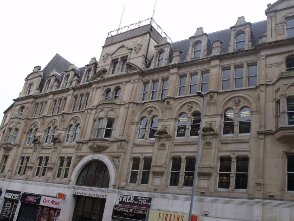 The Gazette Buildings was originally Lincolns Inn, lawyers' chambers of 1885 - 86 by W H Ward. Ground floor altered 1928 by W H Martin; mutilated top. What remains is Ward's finest surviving commercial design, an expansion of City Chambers, New Street. The giant arches with their Venetian arrangement recall the splendours of his demolished Colonnade Building. The rich all-over treatment derives from Italian Mannerism; the first floor niches placed illogically above the ground-floor piers from Raphael's Palazzo dell'Aquilla.


