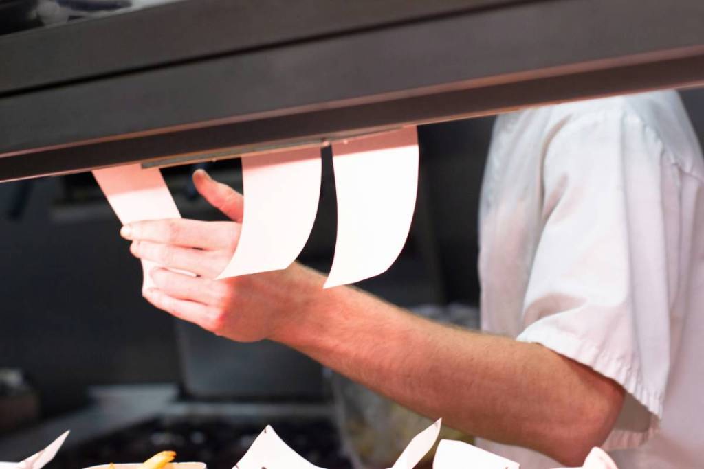 A chef organising kitchen tickets